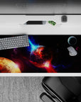 Cinematic deep-space mood desk pad 36x16 inches in inky black, violet dust, and electric blue glow.