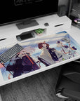 Silver-haired anime operator with red accents and shield gear on desk pad 40x20 inches.