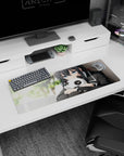 Shy anime schoolgirl hugging a panda plush on a 32x12 inches mouse pad, with blurred green background.