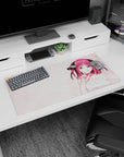 32x16 inches Nino Nakano mouse pad from The Quintessential Quintuplets, mischievous smile on a pink desk.