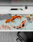 Striking 36x16 desk pad highlights orange and white koi scales, cherry blossoms, and Japanese clouds in stunning detail