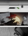Striking 36x16 desk pad highlights lone samurai, crimson tree, and misty shadows in stunning artistic detail