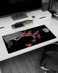 Modern 32x16 inches mouse pad featuring plum blossoms, with snow-covered branches and vibrant red flowers creating a hopeful, contrasting design.