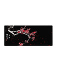 Mouse pad featuring plum blossoms, 28x12 inches, with snow-covered branches and vivid red flowers, creating a stunning contrast of beauty and strength.