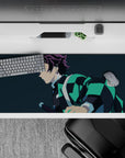 Anime desk pad featuring Tanjiro from Demon Slayer, 36x16 inches, with teal-black haori on navy-blue background.