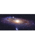 Galaxy swirl desk pad 36x16 inches with tiny stars and a soft glowing core for smooth mouse tracking.