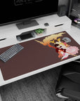 Three anime heroes in a protective embrace under sweeping flames, desk pad 40x20 inches with staff detail.