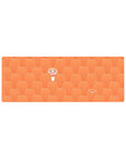 32x12 inches anime mouse pad with repeating sleepy orange hamsters and a grinning girl in a cozy scarf pattern.