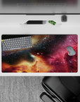 Deep navy and black starfield mouse pad, 32x16 inches, with magenta nebula wash and golden horizon mood.