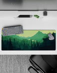 32x12 inches mouse pad with forest explorer, featuring evergreen trees and distant peaks for a serene, adventurous workspace vibe.