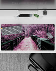 Dynamic 32x16 desk mat combines lush trees, iron bridge, and pink hues for impactful yet soothing visuals