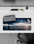 Moody navy and deep blue mouse pad, 28x12 inches, with silvery stars and a warm sunrise glow.