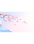 Desk pad featuring cherry blossoms, 40x20 inches, with soft pink petals falling against a pastel sky and serene Mount Fuji in the background.