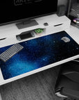 40x20 inches desk pad showing a deep space scene with tiny starbursts and scattered stars.