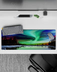 32x12 inches mouse pad featuring the northern lights over a frozen lake, with green, blue, and purple hues creating a tranquil vibe.