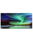 Mouse pad with the northern lights, 32x16 inches, dancing over a frozen lake, featuring green, blue, and purple hues for a peaceful design.