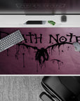 Moody smoky purple Death Note anime desk pad 40x20 inches with dripping ink lettering and splatter art.
