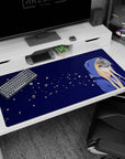 Blonde anime girl in oversized blue hoodie, shy side glance on 40x20 inches desk pad with starry specks.