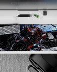 36x16 inches anime desk pad in deep-space blues with red, gunmetal gray, and white panels, sparks flying.