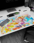 Winking orange-haired anime girl shooting a cute water gun desk pad 40x20 inches, playful pin-up scene.