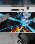 Dynamic 40x20 inch anime desk pad showcasing Goku's powerful energy attack piercing through darkness