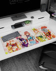 36x16 inches anime desk pad scene of five smiling kimono girls amid drifting pink petals like a tiny festival.