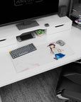 28x12 inches mouse pad showing chestnut twin-tail anime girl waving, glossy eyes, floral blouse and navy skirt.