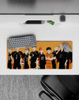 Warm sunset-orange anime mouse pad 28x12 inches with black jerseys, white numbers, and bright libero.