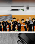 Sunset-orange gym backdrop anime desk pad 36x16 inches, bold black lineup and punchy green-red balls.