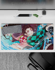 High-quality 32x16 inch mouse pad showcasing Tanjiro and Nezuko's fierce bond for gaming setups