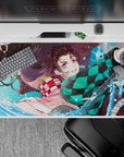Dynamic 40x20 inch anime desk pad showcasing Tanjiro and Nezuko's fierce bond and intense action