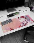 Smiling anime shrine maiden with fox ears and delicate hair, petals behind, desk pad 36x16 inches.
