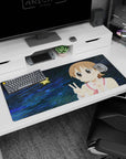 Kawaii anime girl desk pad 36x16 inches with glossy eyes, pink cheeks, and peace signs on a starry blue scene.
