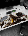Anime desk pad 40x20 inches showing a yellow-lensed fighter vs cracked-armor rival, steel focus in close-up.