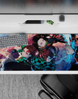 Sleek 36x16 inch desk pad featuring Tanjiro and Nezuko's dynamic water and flame art for anime fans