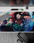 Dynamic 40x20 inch anime desk pad showcasing Tanjiro and Nezuko's unwavering determination in battle