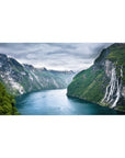 Mouse pad featuring towering fjord cliffs, 40x20 inches, with cascading waterfalls and emerald waters for adventure and tranquility.