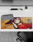 Megumin from KonoSuba laying flat, thumbs up on a 32x12 inch mouse pad, showcasing her crimson cloak and witch hat.