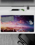 Serene 32x16 mouse pad featuring a stunning sunset over waterfalls and mountains, transitioning into a starry night for a calming workspace vibe
