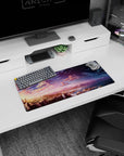Tranquil 28x12 mouse pad with a sunset turning into a starry sky over waterfalls and mountains, perfect for adding peace and inspiration to your desk