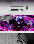 36x16 inches desk pad showcasing Tanjiro Kamado in action, with fiery reds and purples illustrating the intense power of his attack.