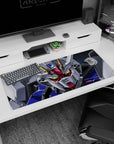 Gundam SEED Strike Gundam glaring close-up desk pad 36x16 inches, metallic highlights and cockpit vibe.