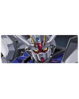 32x12 inches anime mouse pad with Strike Gundam face-shot in space, white armor, red accents, blue panels.