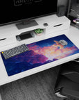 Howl and Sophie drifting by a giant winged creature on a 36x16 inches anime desk pad in starry skies.