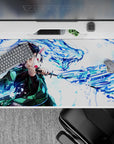 Dynamic 40x20 inch anime desk pad showcasing Tanjiro's powerful water surge and battle stance