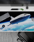 Moody black sky desk pad 40x20 inches with bright blues, soft clouds, and calm glowing horizon.
