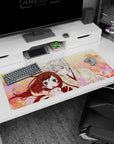 Silver-haired fox boy leans close to amber-eyed girl on anime desk pad 36x16 inches, scarf and petals.