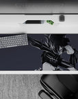 Moody monochrome anime desk pad 36x16 inches in smoky grays with sharp ink-streak hair highlights.