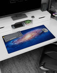 Star-sprinkled spiral nebula scene on a 32x16 inches mouse pad, galaxy swirl drifting underhand.