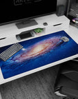 Space vortex scene desk pad 40x20 inches featuring a swirling galaxy core and scattered starlight.
